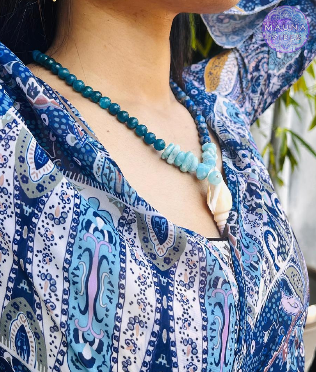 "Model wearing Three Seas Necklace – elegant handmade gemstone necklace with blue ocean tones and silver seashell pendant."