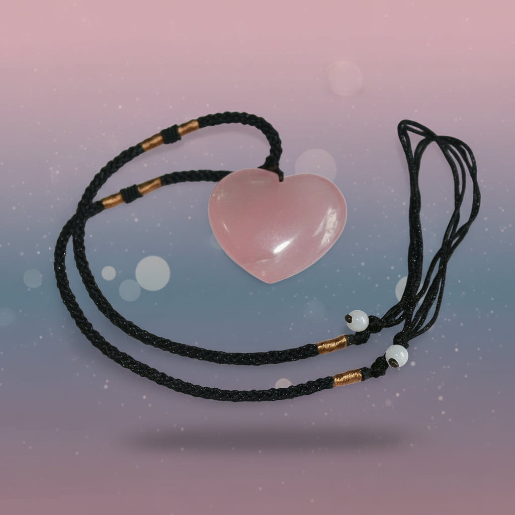 Heart-shaped pink stone pendant on a black cord against a white background