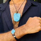 a man wearing a larimar stone bracelet and necklace