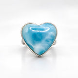 A heart-shaped Larimar ring with a polished silver bezel setting, displayed on a clean white background.