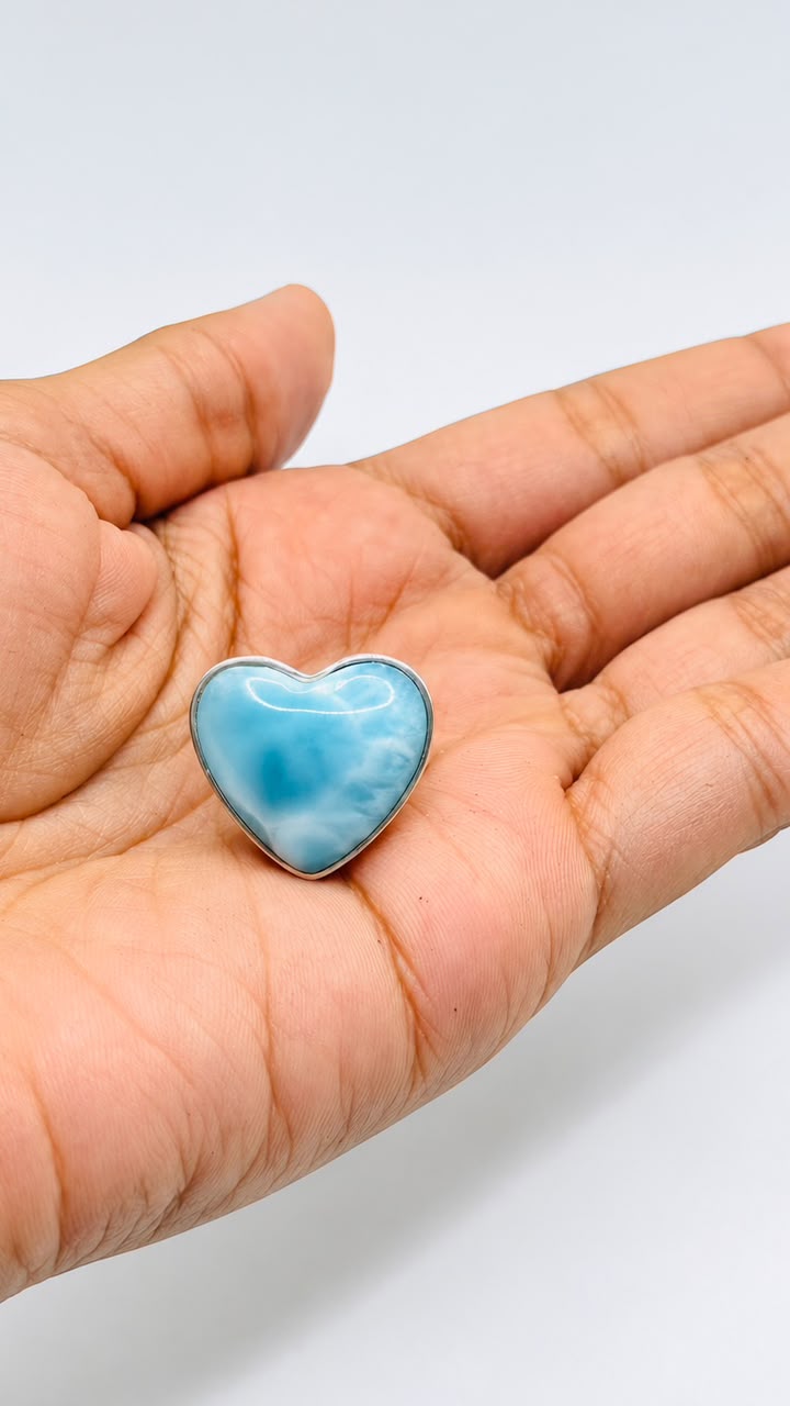 A heart-shaped Larimar stone pendant.