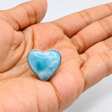 A heart-shaped Larimar stone pendant.