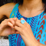 a woman wearing a arimar stone ring