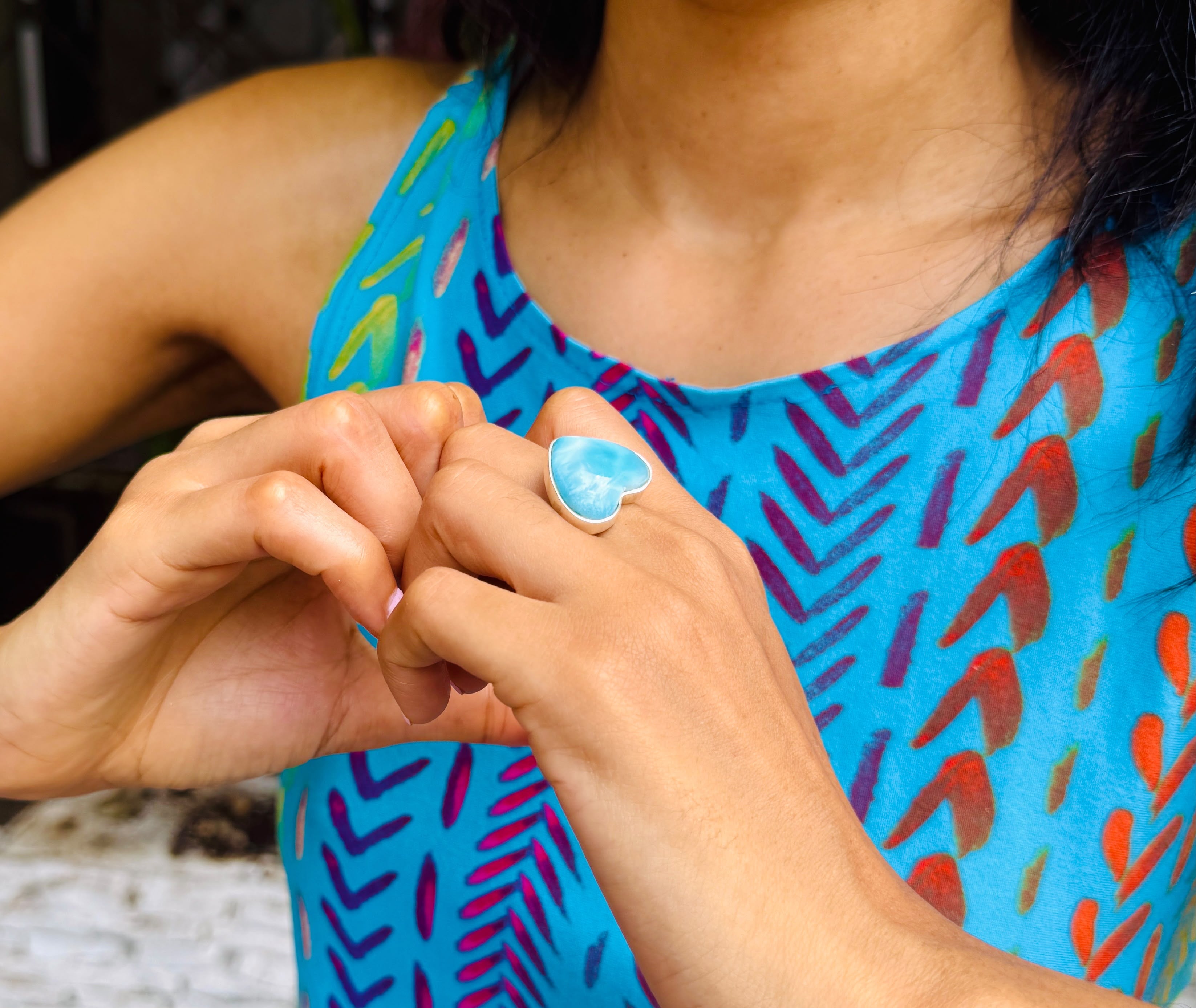 a woman wearing a arimar stone ring