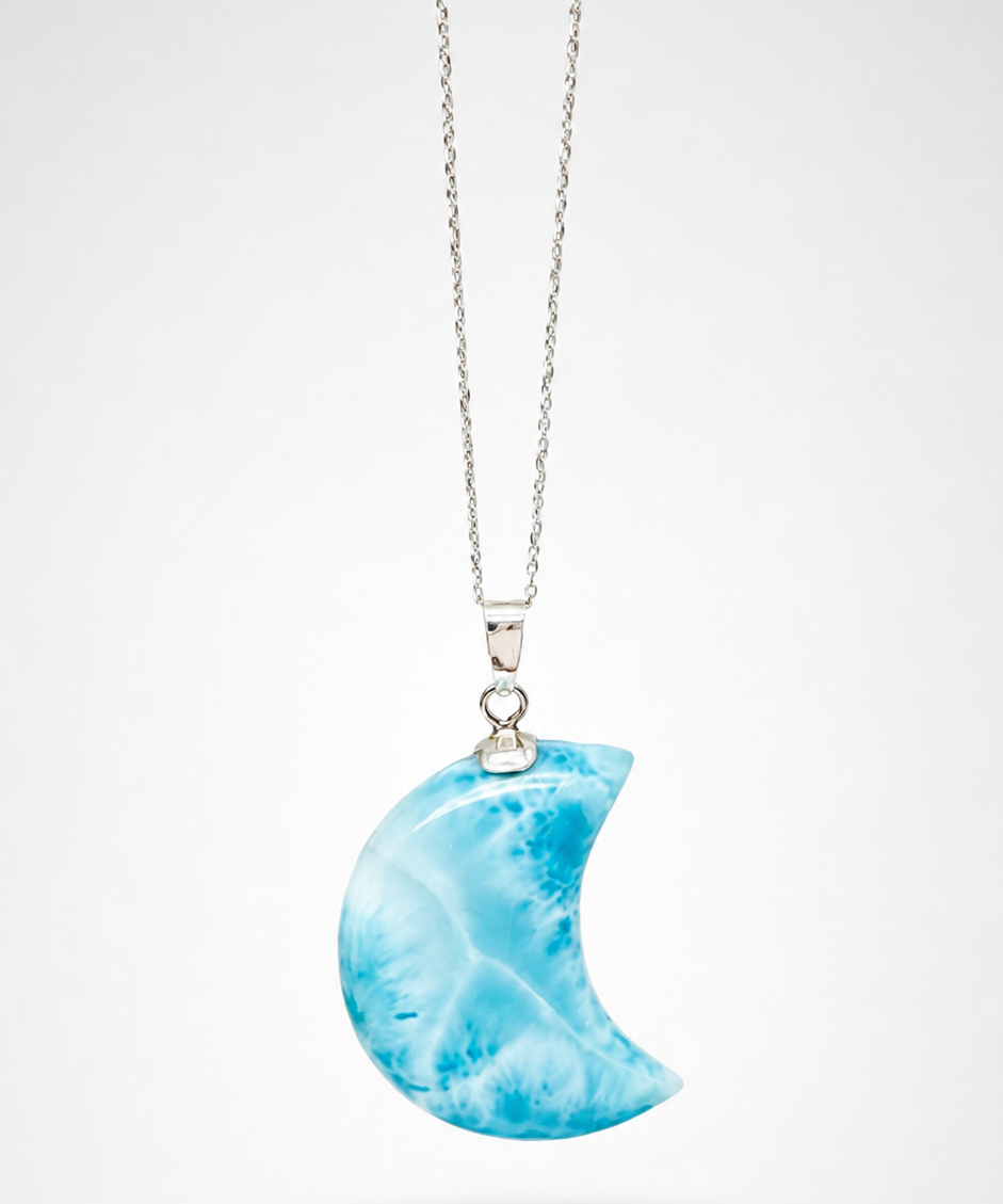 A silver necklace with a crescent moon pendant made of marbled blue and white stone, shown against a light gray background.