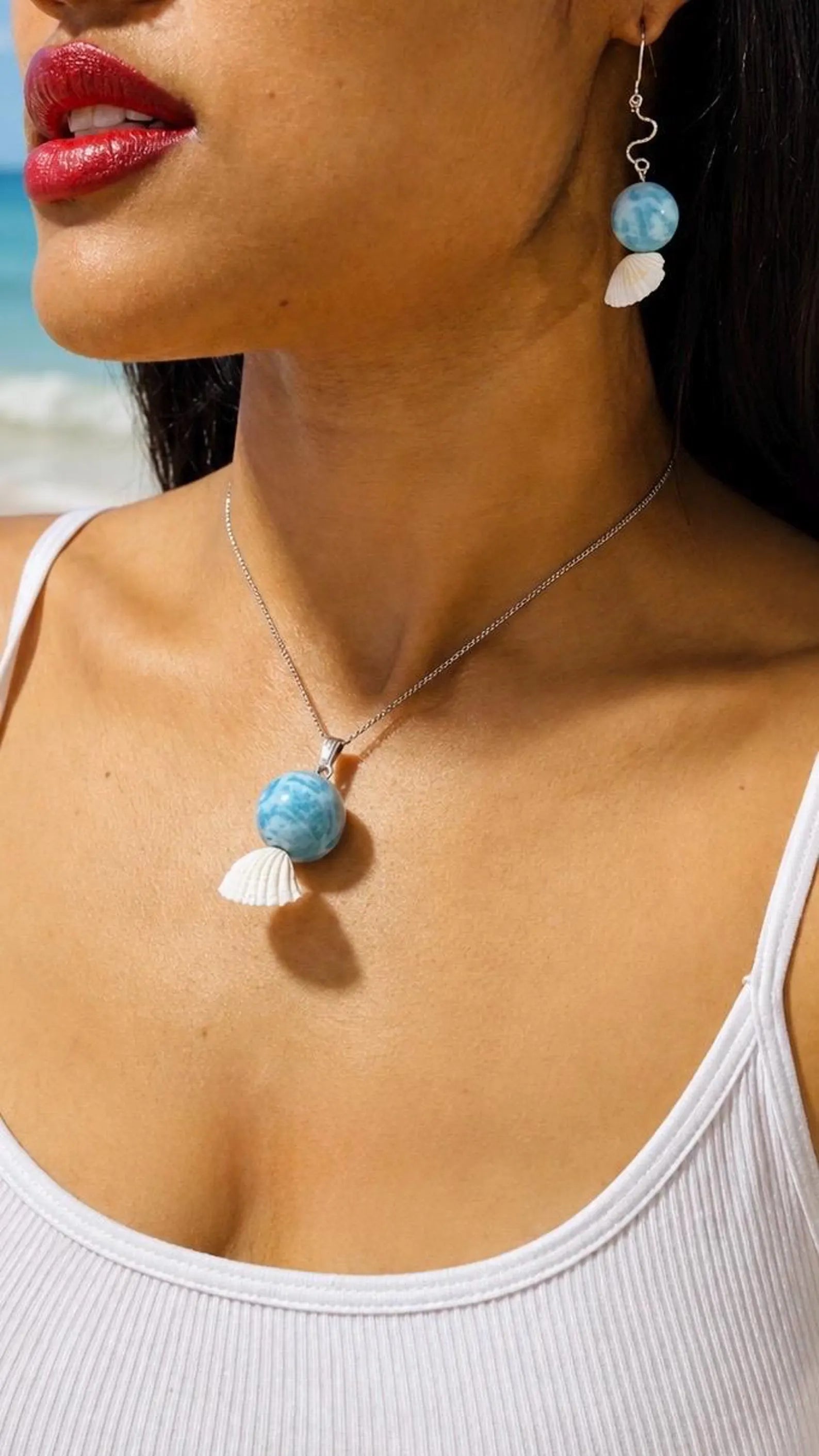girl wearing larimar necklace and earrings
