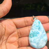 A teardrop-shaped Larimar pendant