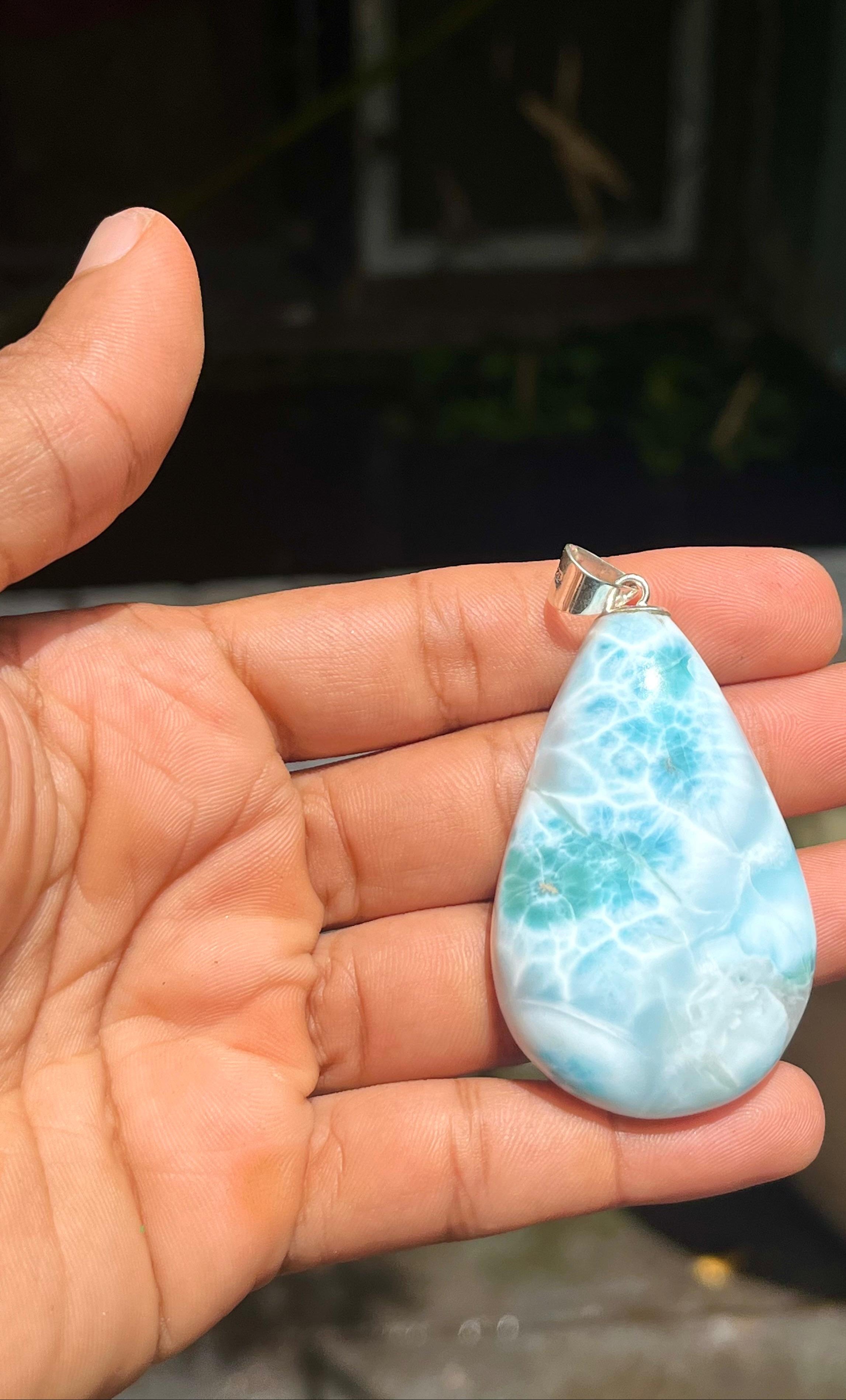 A teardrop-shaped Larimar pendant