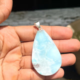 A teardrop-shaped Larimar pendant