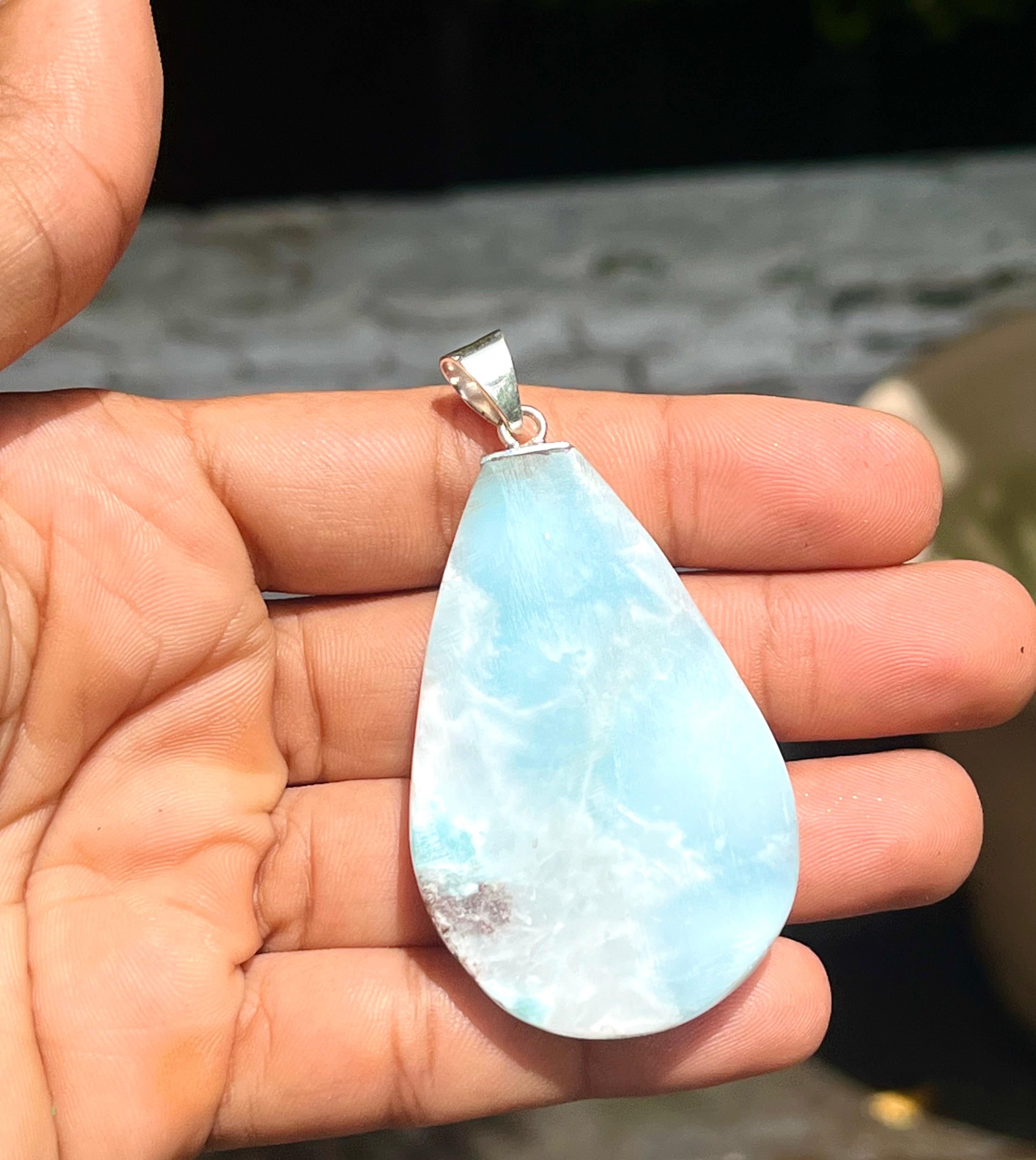 A teardrop-shaped Larimar pendant