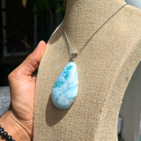 A teardrop-shaped Larimar pendant