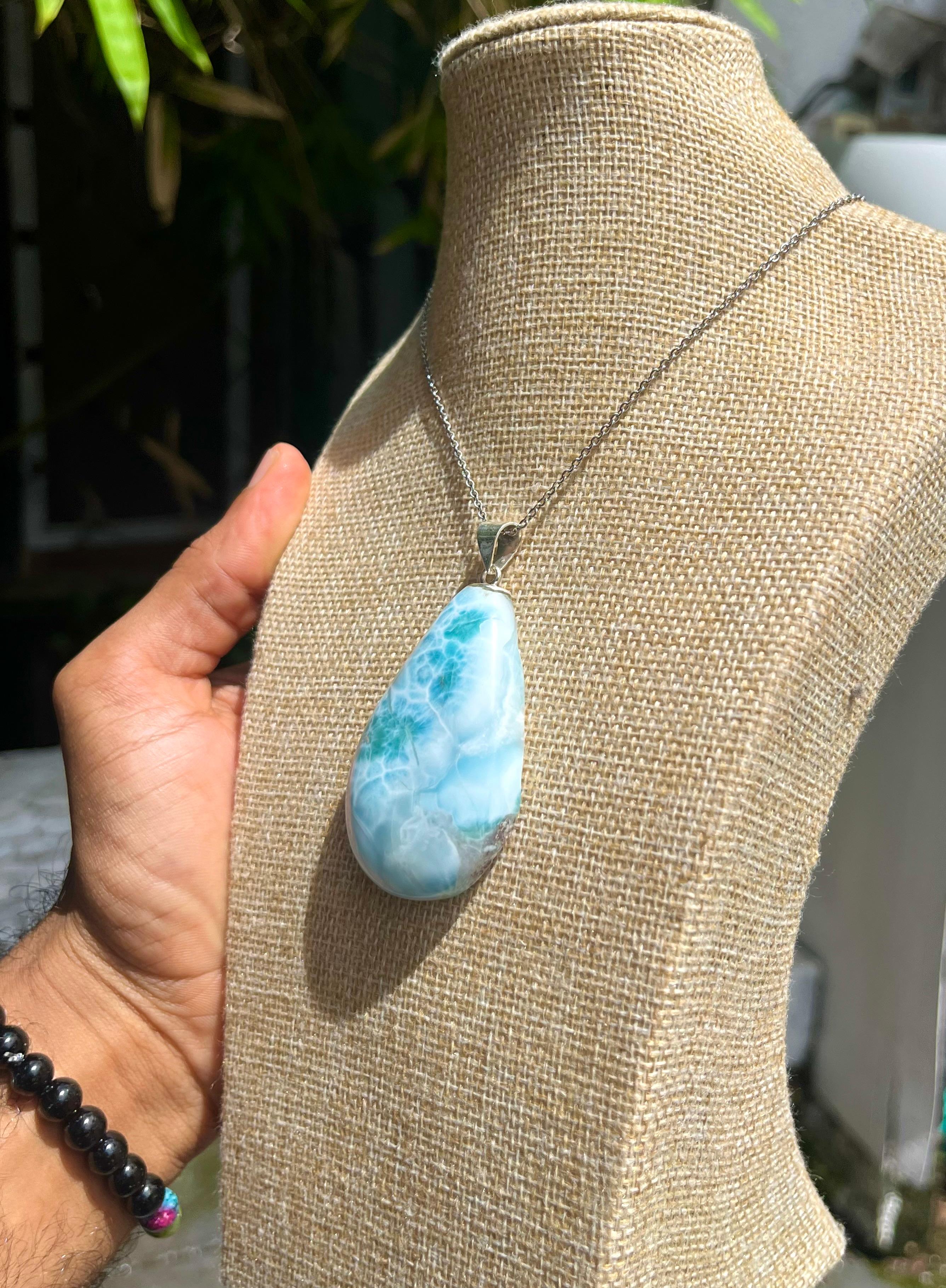 A teardrop-shaped Larimar pendant
