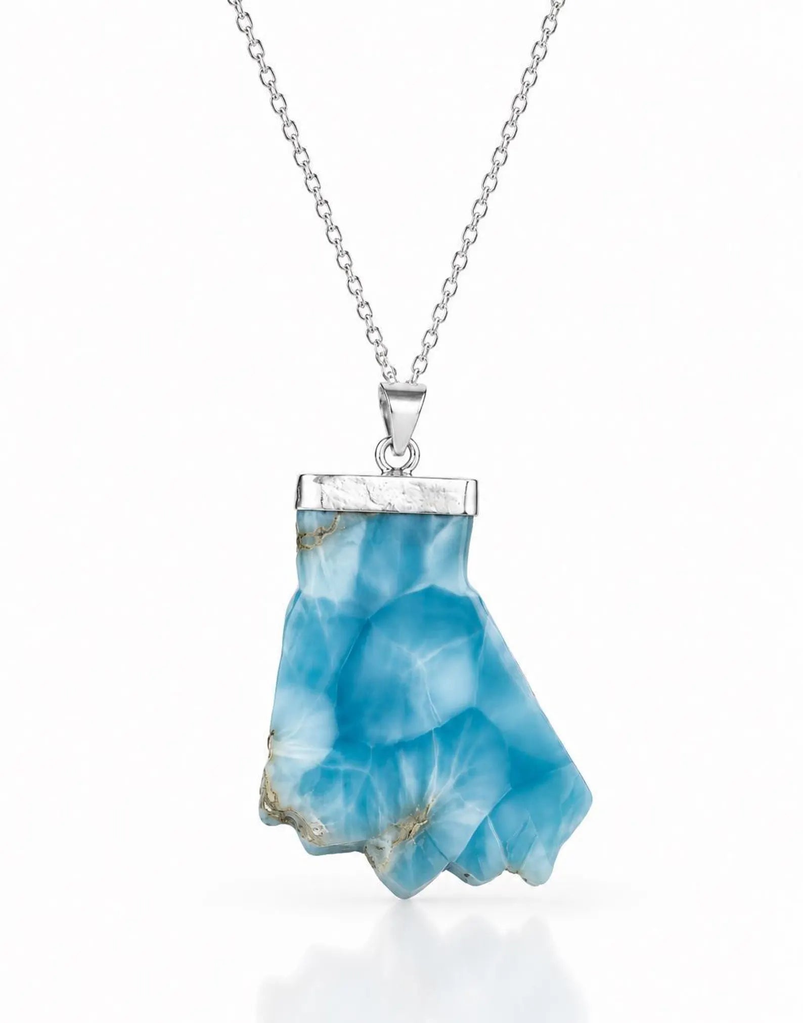 A silver necklace featuring a polished bluelarimar  crystal pendant with natural inclusions, suspended from a delicate silver chain against a white background.