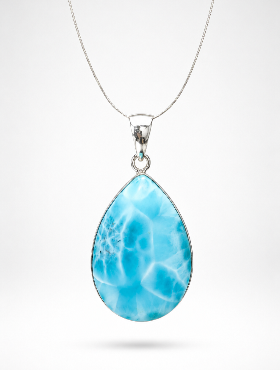 A Larimar teardrop-shaped pendant necklace featuring a vibrant blue marbled stone with white veining, suspended from a delicate silver chain against a light gray background.