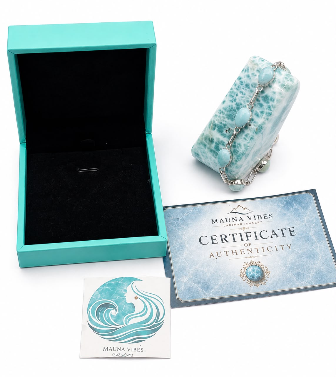 A Mauna Vibes authenticated jewelry box set featuring a turquoise and white baroque stone clutch purse with a silver chain, an open turquoise presentation box with a black velvet interior, a Certificate of Authenticity, and an authenticity card on a white background.