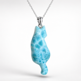 A silver Larimar Cat necklace featuring a pendant carved from light blue marbled Larvamar stone, shown against a clean white background.