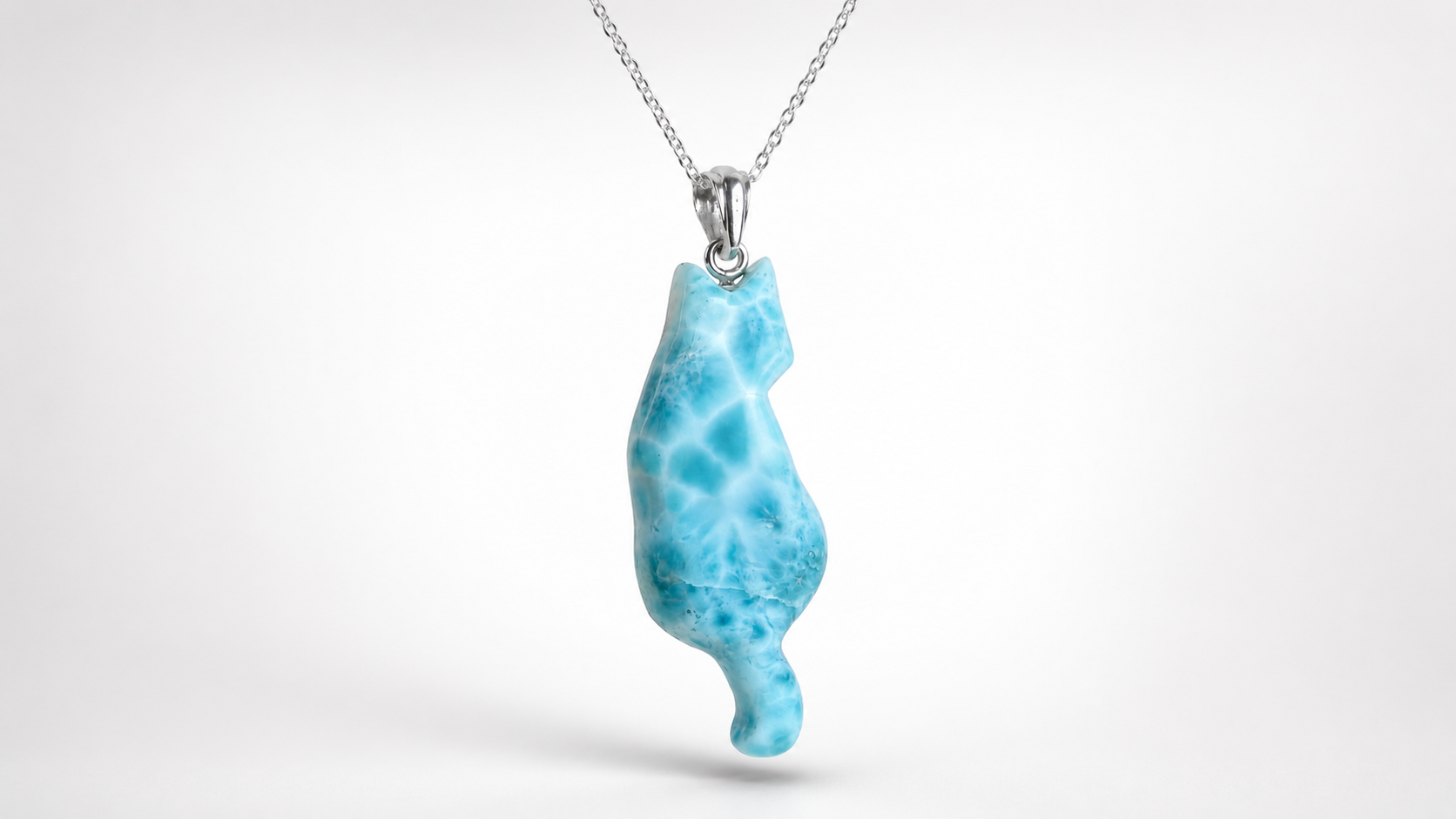A silver Larimar Cat necklace featuring a pendant carved from light blue marbled Larvamar stone, shown against a clean white background.