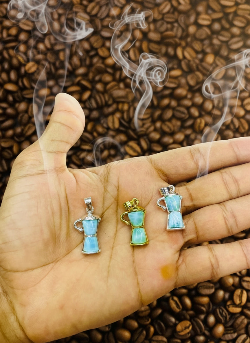 A hand holding Larimar Coffee Maker Pendant