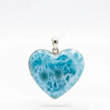 Heart-shaped blue pendant on a white background