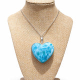 Larimar Necklace with a blue heart-shaped pendant on a beige mannequin bust.
