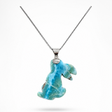 A silver chain necklace featuring a Larimar pendant with a Rabbit carved from  shown against a plain white background.