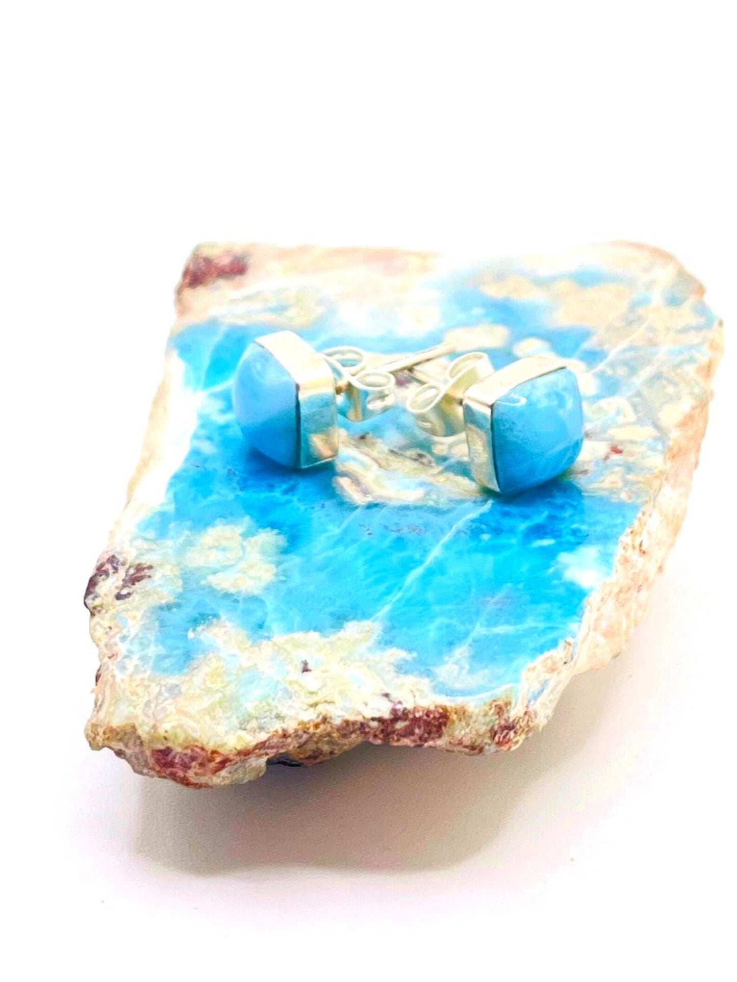 Blue  Larimar 
and white decorative stone with small figurines on a white background