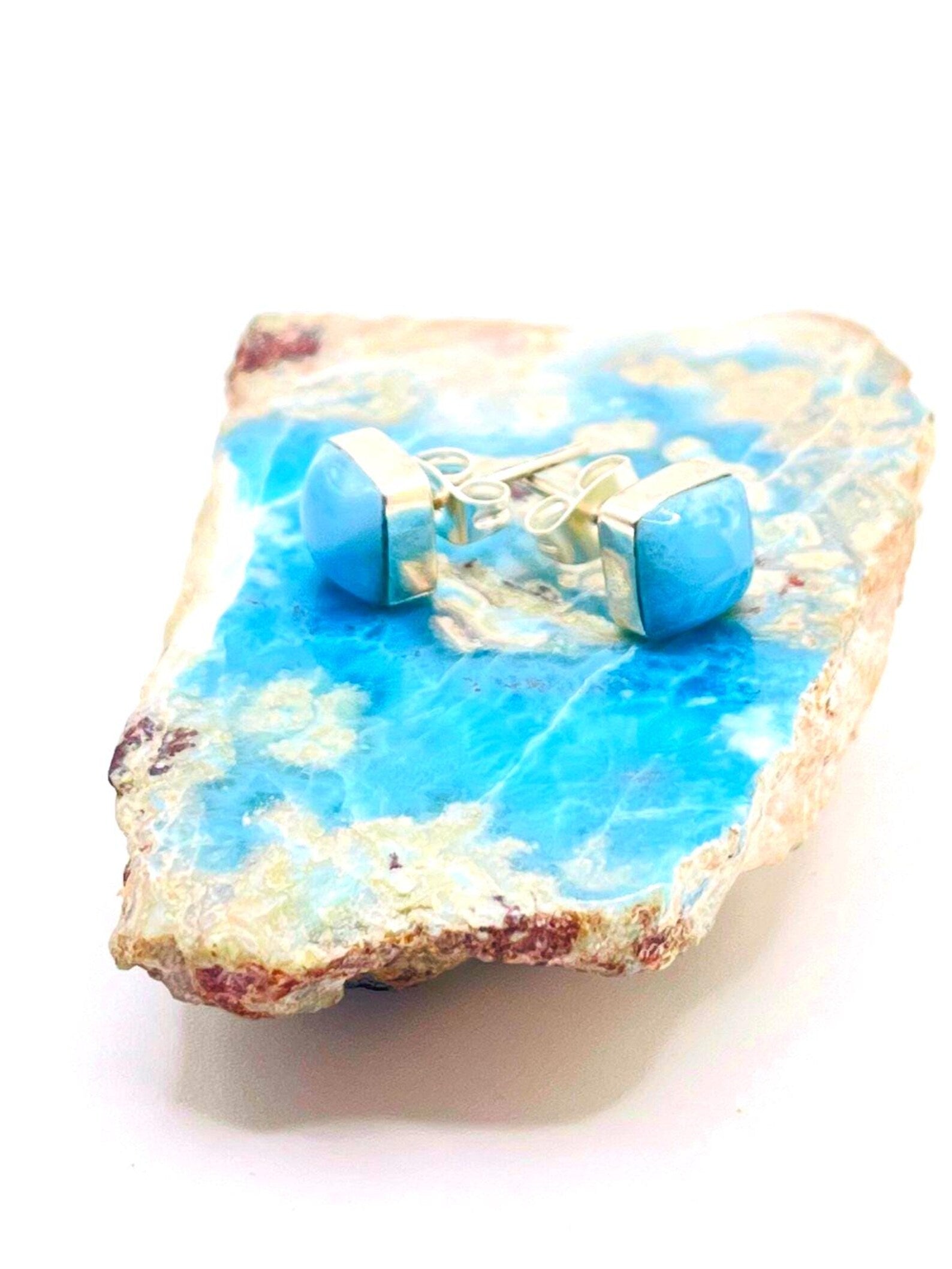 Blue  Larimar 
and white decorative stone with small figurines on a white background