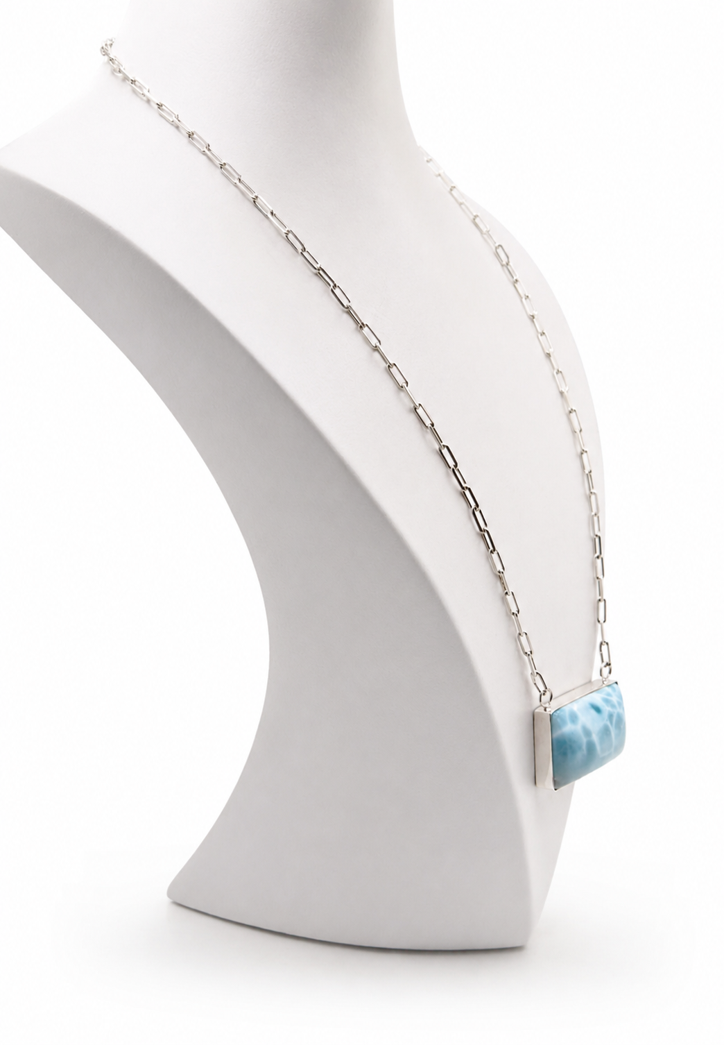 Necklace with a larimar pendant on a white mannequin bust