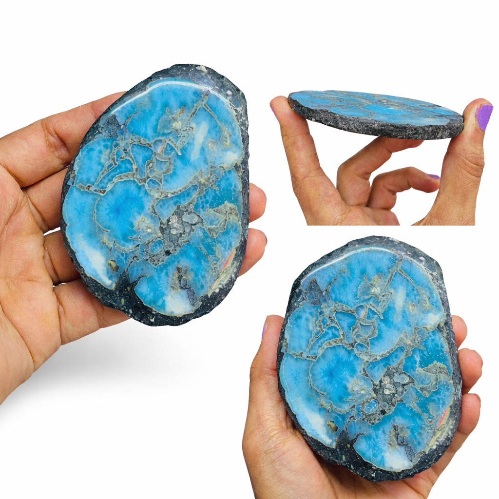 Blue and gray stone with intricate patterns held by a hand on a white background