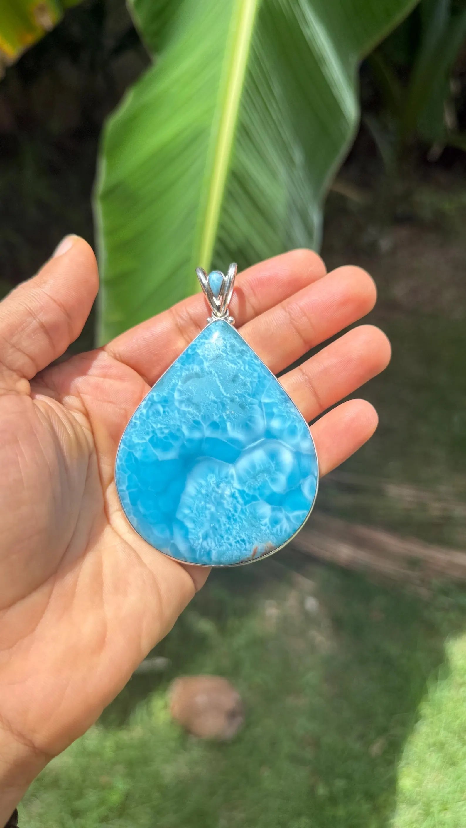A Larimar Jewlery Pendant in natural sunlight 