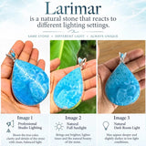 A product comparison graphic for a Larimar teardrop pendant, showing three different views of the blue stone pendant held in a hand under different lighting conditions: professional studio lighting, natural full sunlight, and natural dark room light. The top text explains that the stone reacts to different lighting settings.