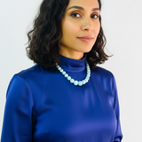 Woman wearing a blue larimar necklace