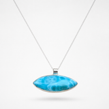 A silver Larimar pendant necklace featuring a horizontally oriented, teardrop-shaped Larimar stone with vibrant blue and white marbled patterns, suspended from a delicate silver chain against a clean white background.
