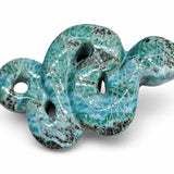 A carved  Larimar stone shaped like a coiled snake, featuring a glossy turquoise and teal body with prominent black and dark gray veining, set against a plain white background.