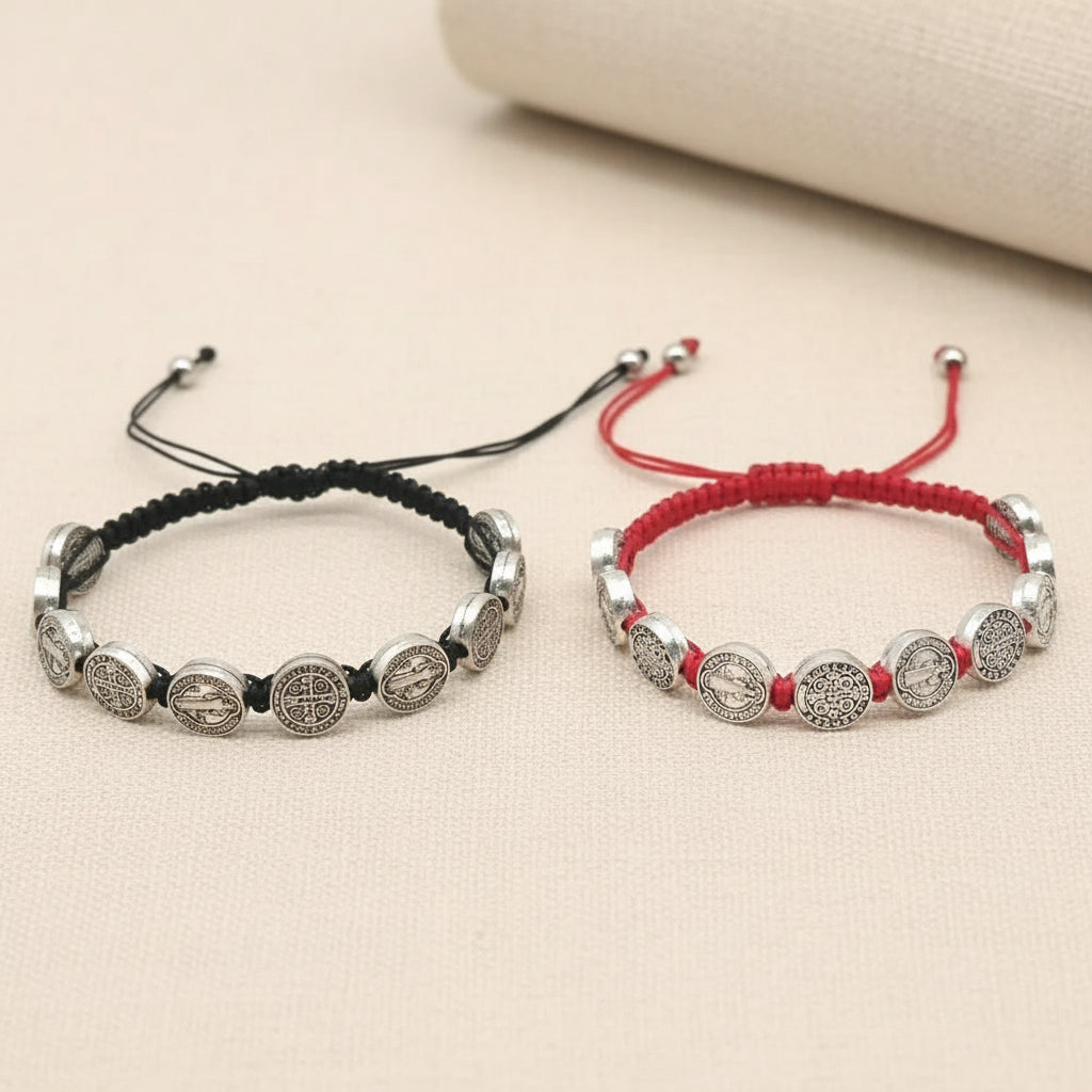 Two bracelets, one black and silver, the other red and silver, on a white background.