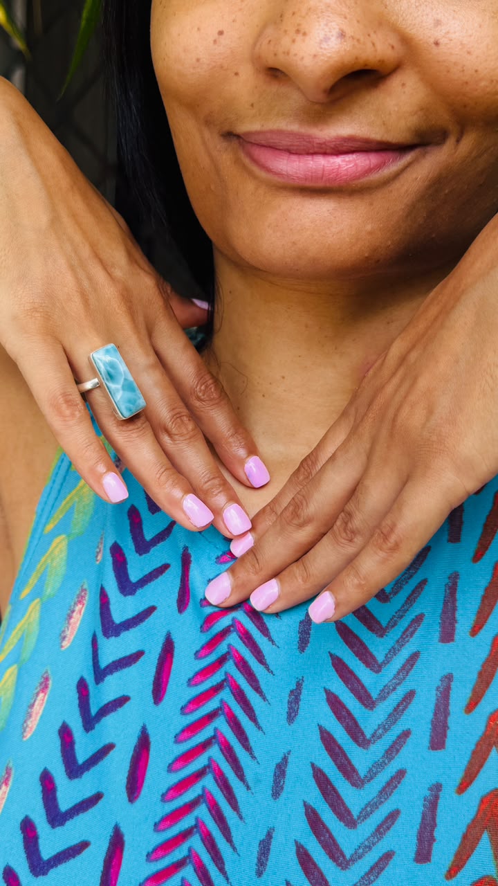 a woman wearing a larimar ring