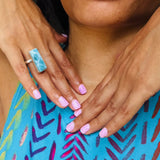 a woman wearing a larimar ring