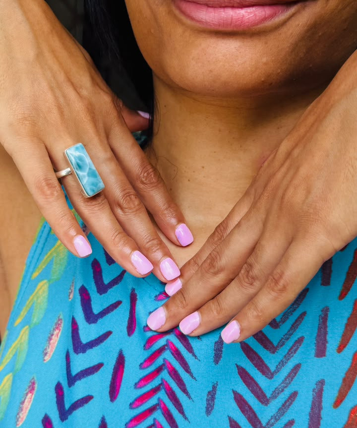 a woman wearing a larimar ring