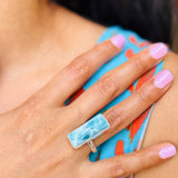 a woman wearing a larimar ring