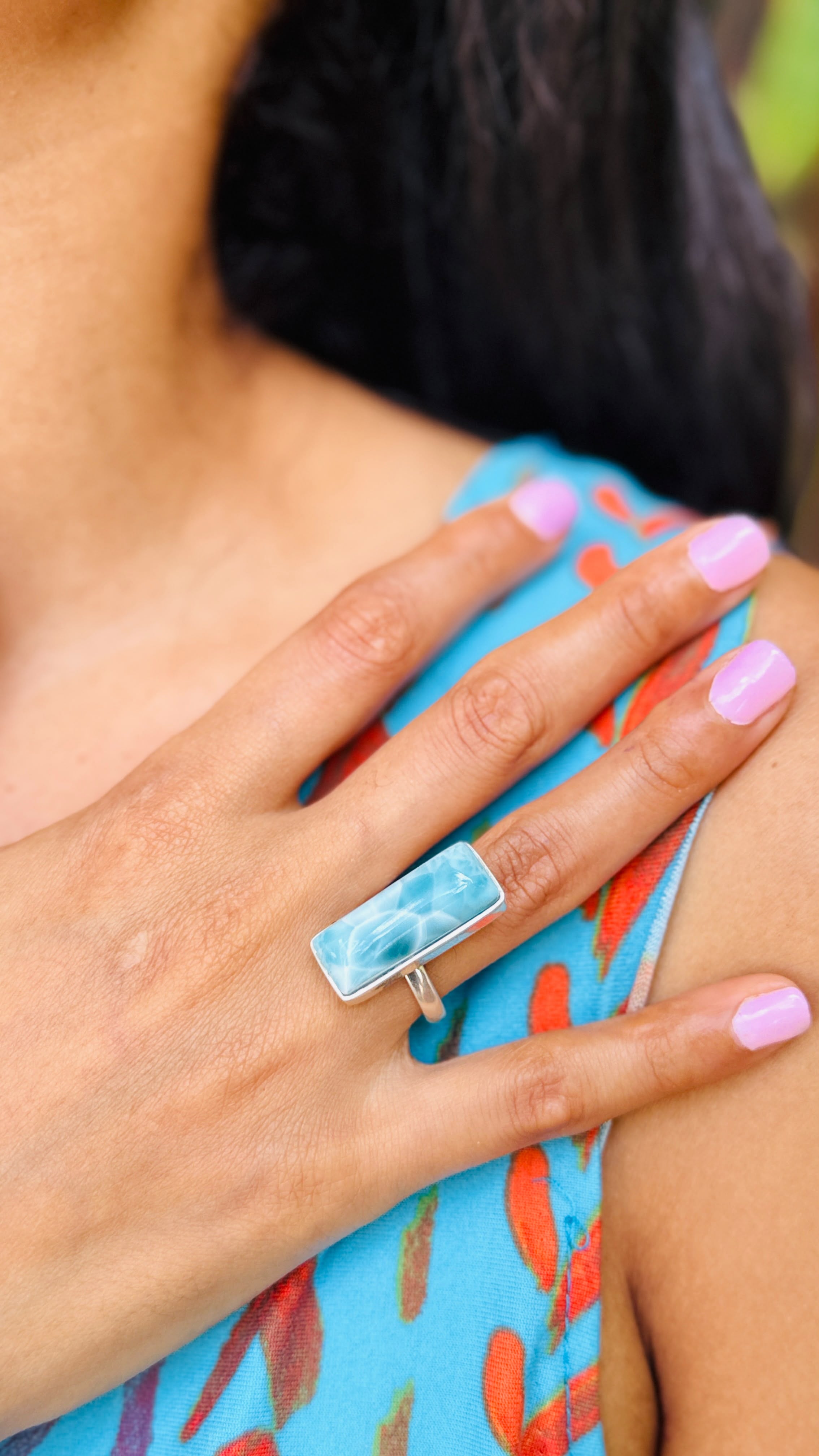 a woman wearing a larimar ring