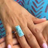 a woman wearing a larimar ring