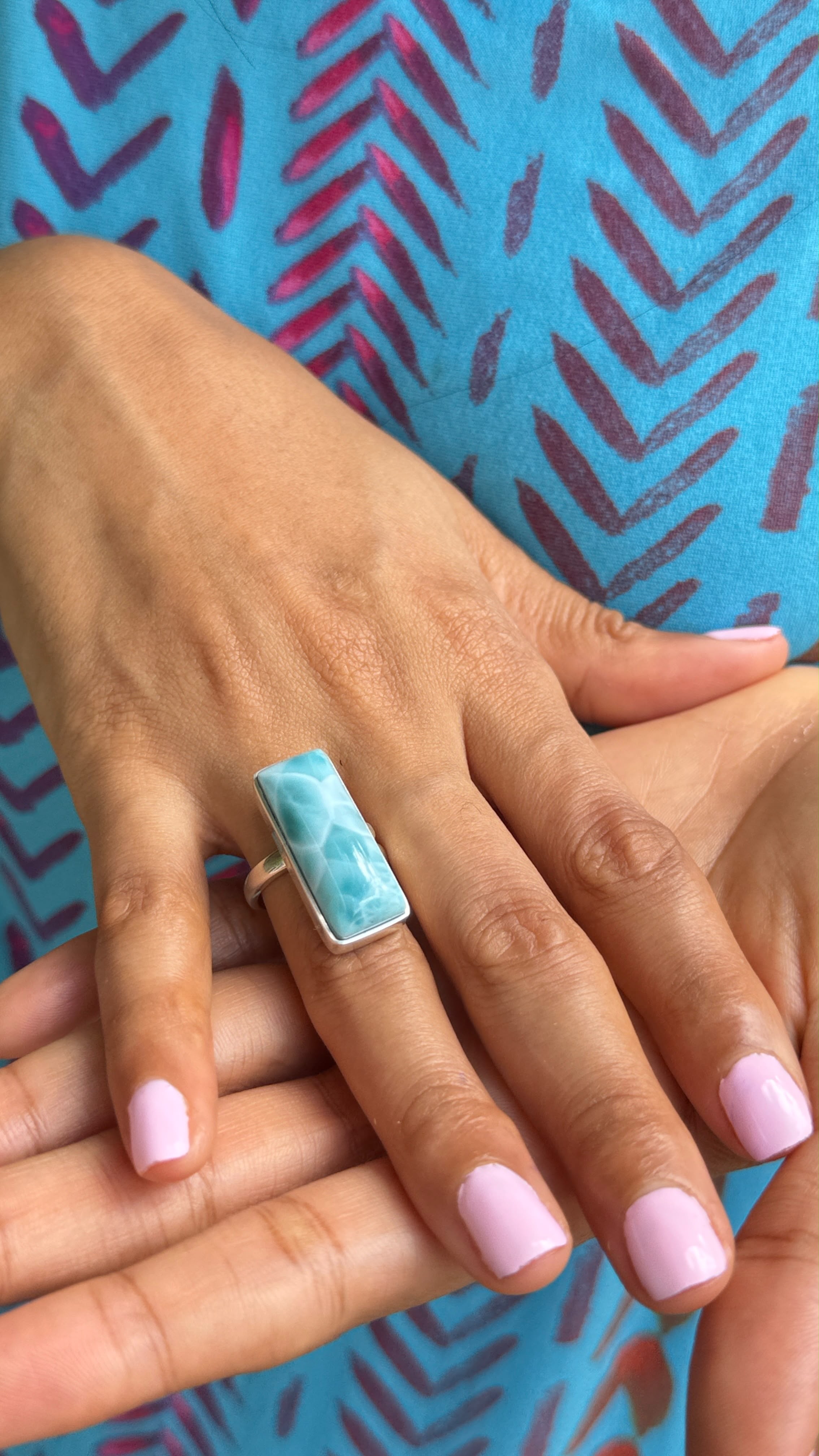 a woman wearing a larimar ring