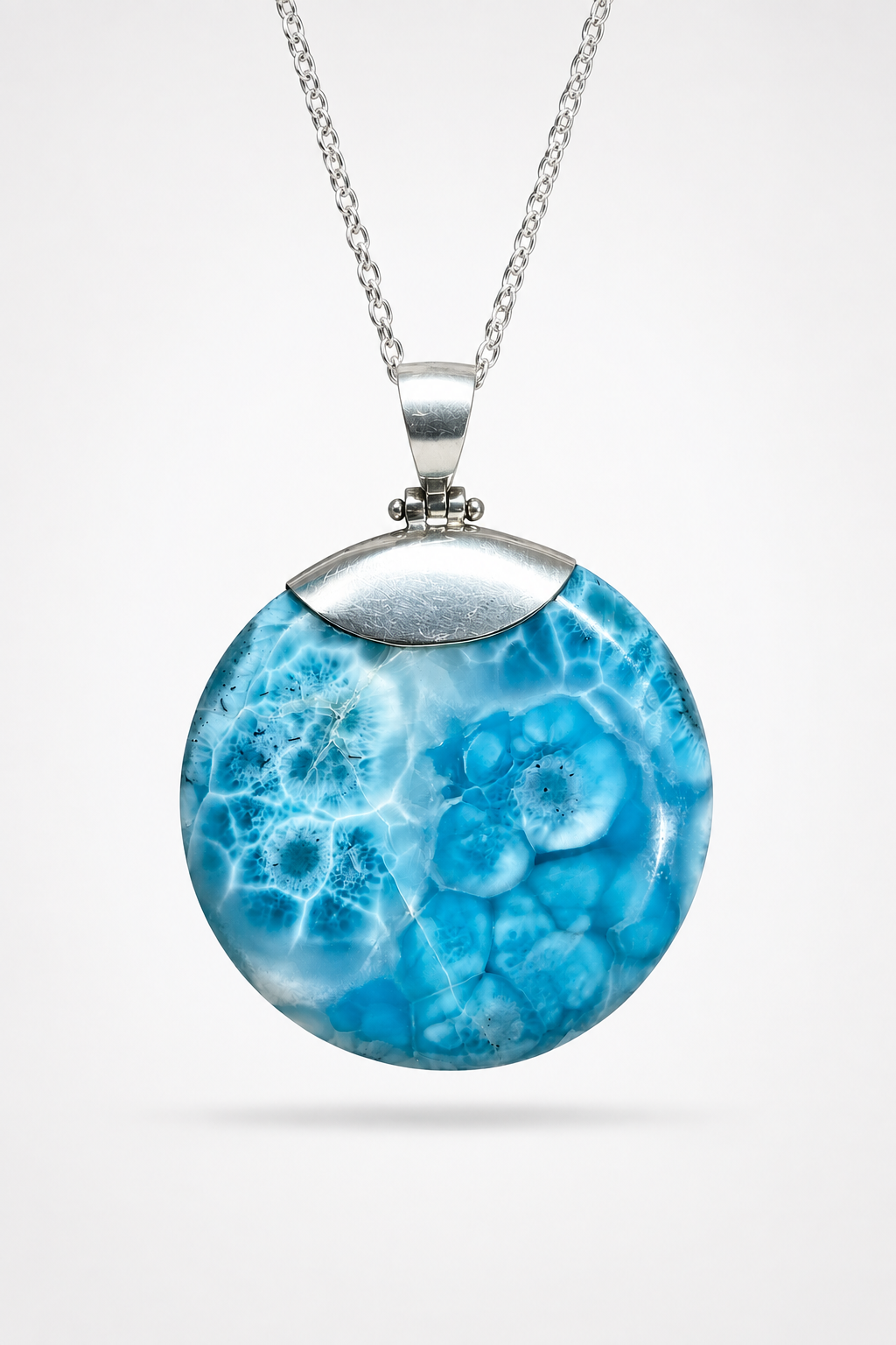 AAA Larimar round pendant worn on sterling silver chain – Caribbean blue fractal pattern on white linen – Mauna Vibes