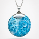 AAA Larimar round pendant worn on sterling silver chain – Caribbean blue fractal pattern on white linen – Mauna Vibes