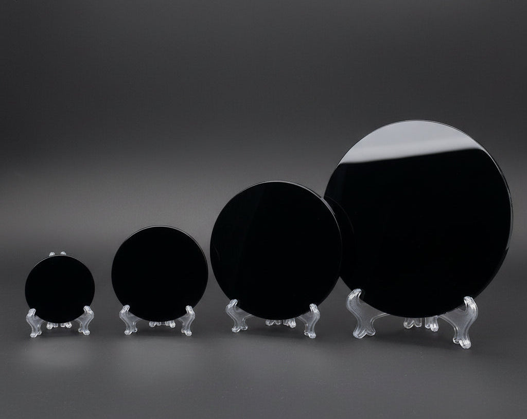 Set of black circular objects on stands against a white background