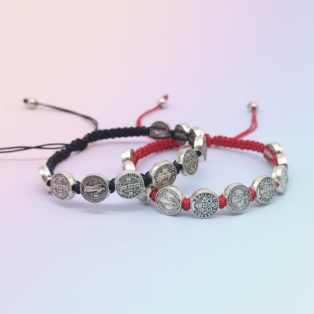 Two bracelets with silver charms on black and red strings against a white background