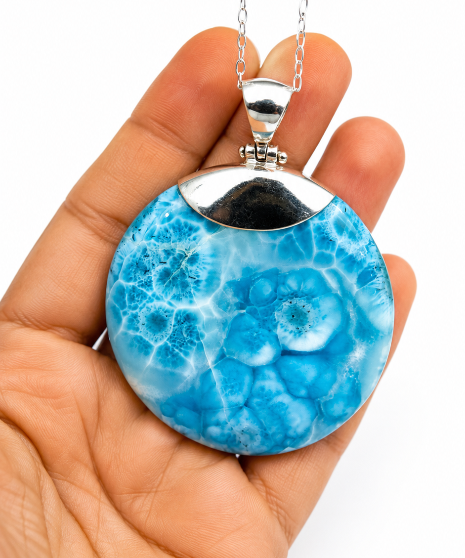AAA Larimar round pendant in hand showing size – 100g genuine Dominican Republic gemstone on sterling silver chain – Mauna Vibes