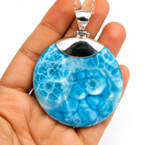 AAA Larimar round pendant in hand showing size – 100g genuine Dominican Republic gemstone on sterling silver chain – Mauna Vibes