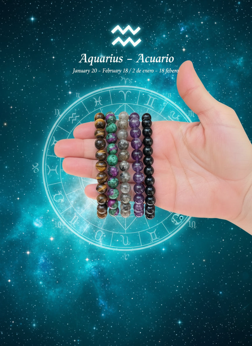 Hand holding four beaded bracelets in front of a natural background with plants.