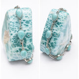 A pair of silver chain larimar bracelets  featuring natural light blue and white marbled stone beads, shown from both front and side angles on a white background.